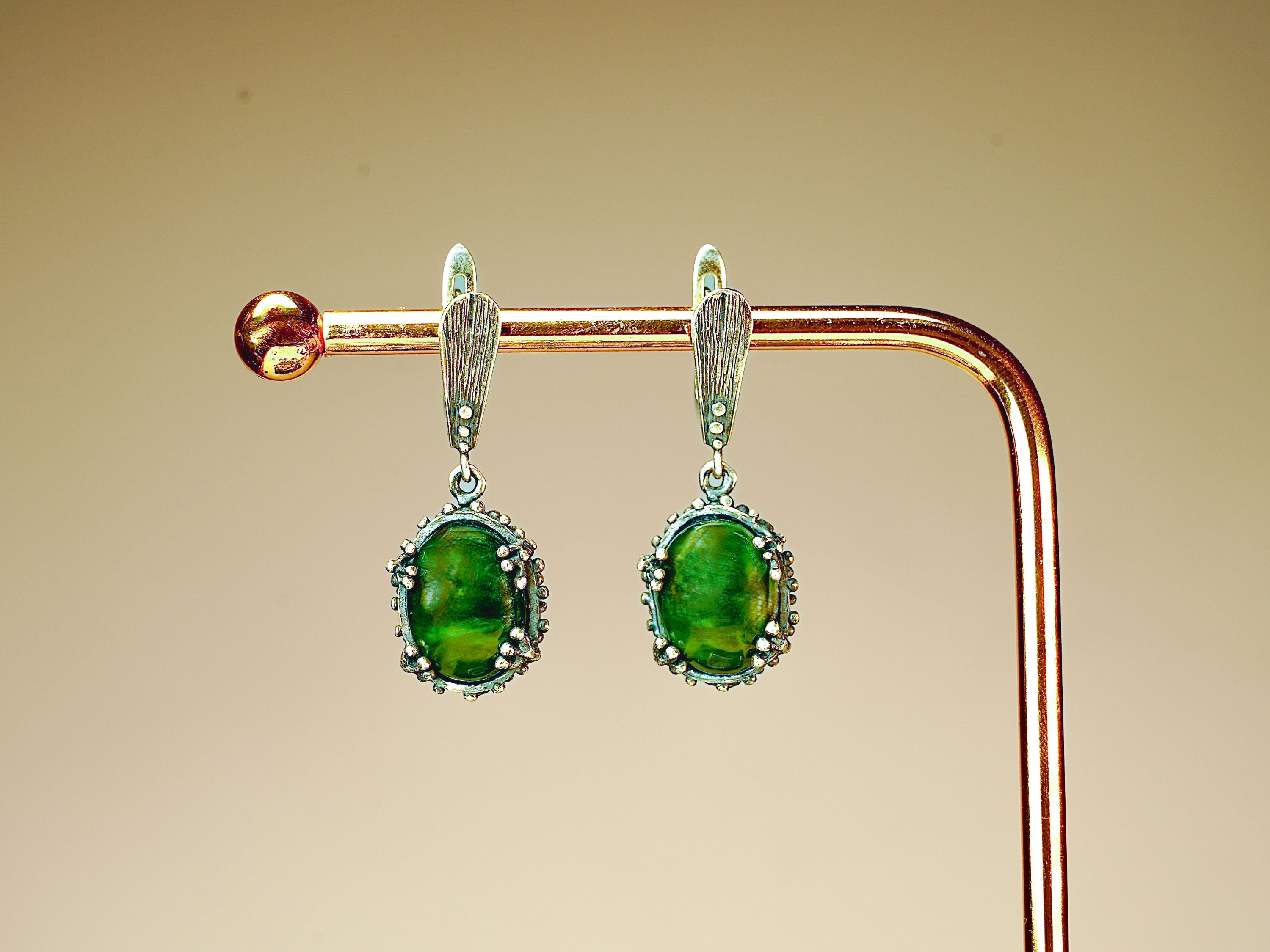 Side profile jade earrings leverback closure silver structure detail