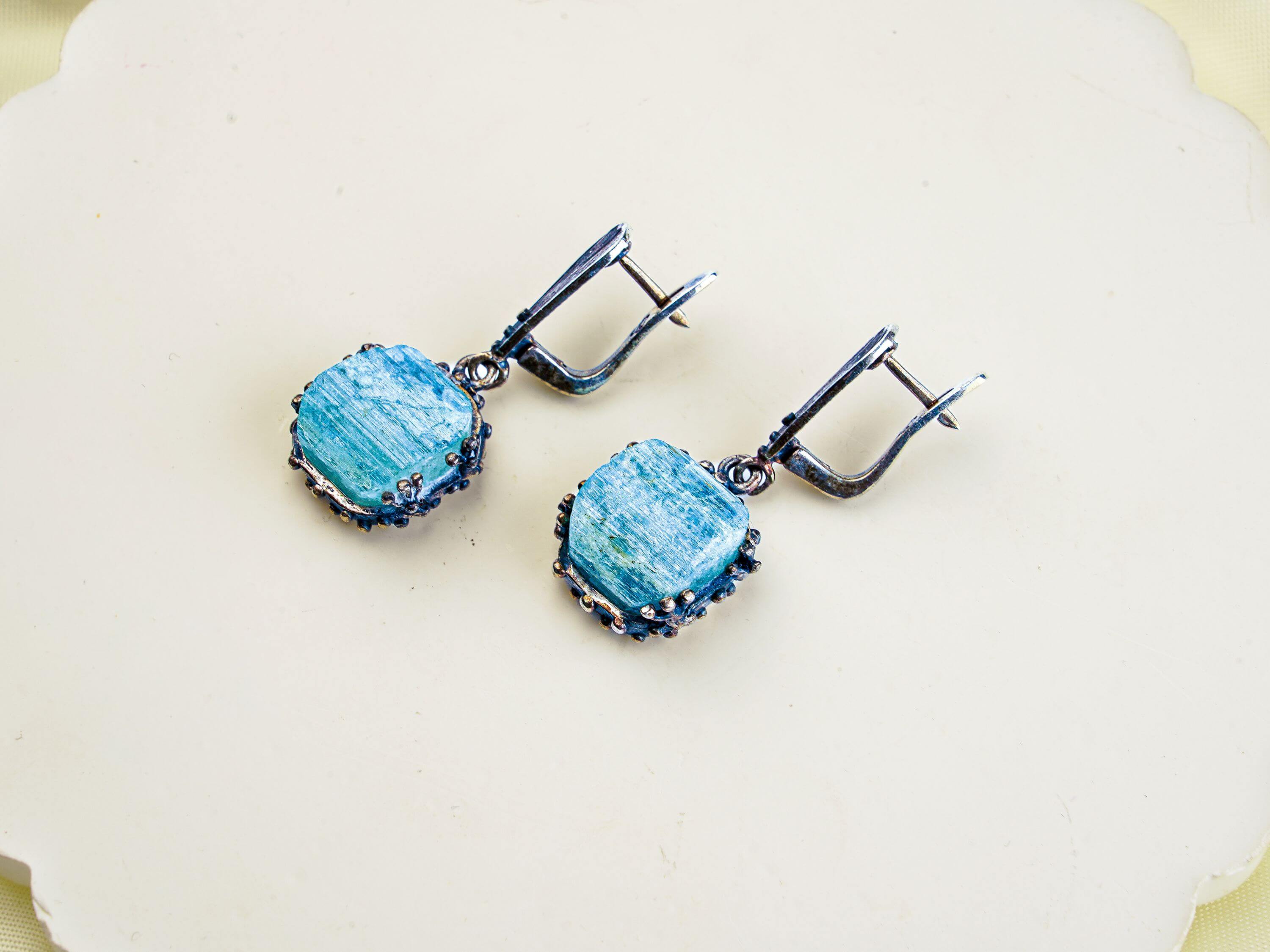 Angle view aquamarine earrings raw aqua crystal silver drop earrings perspective