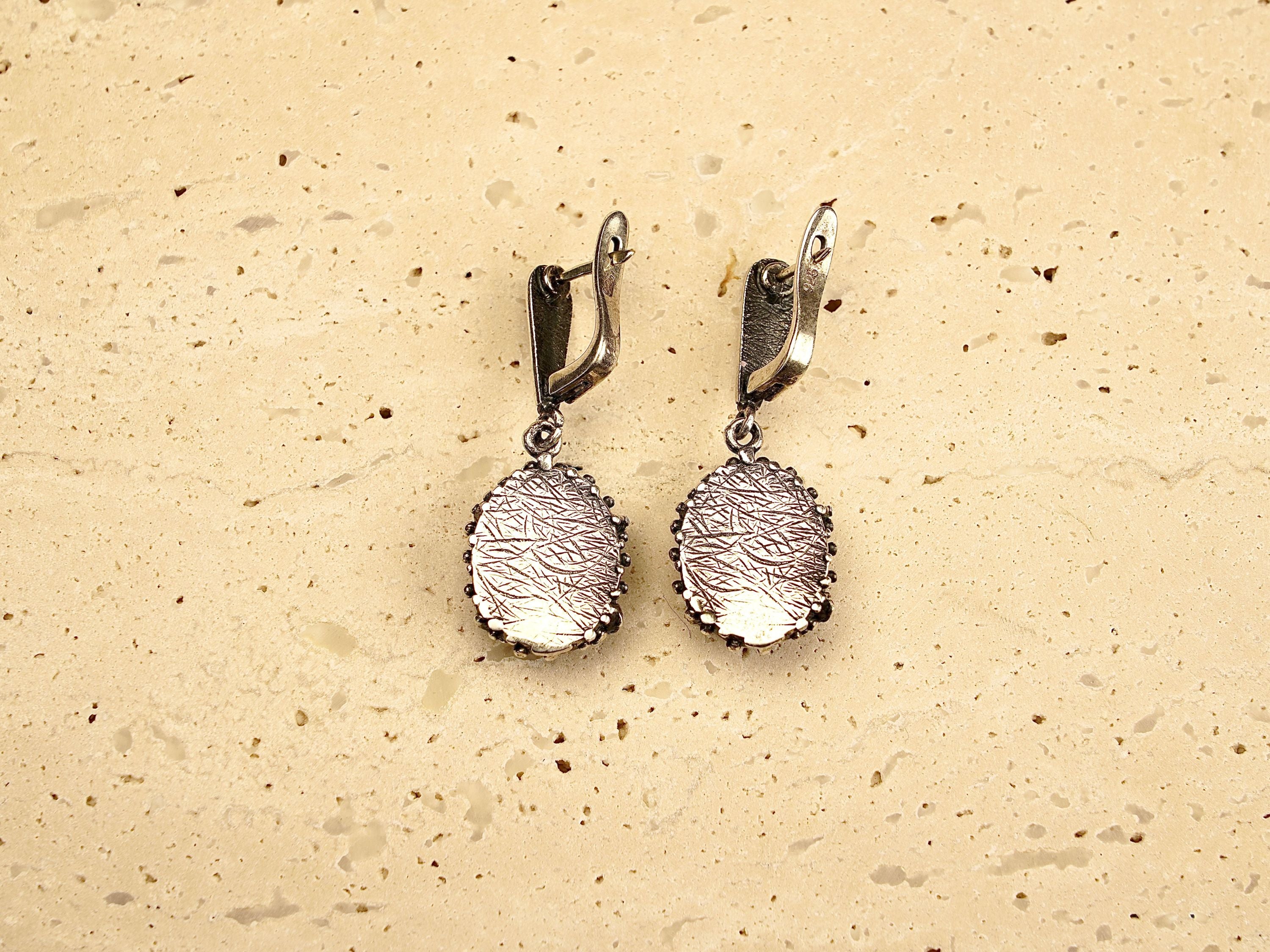 backside of rose quartz earrings, secure leverback sterling silver detail