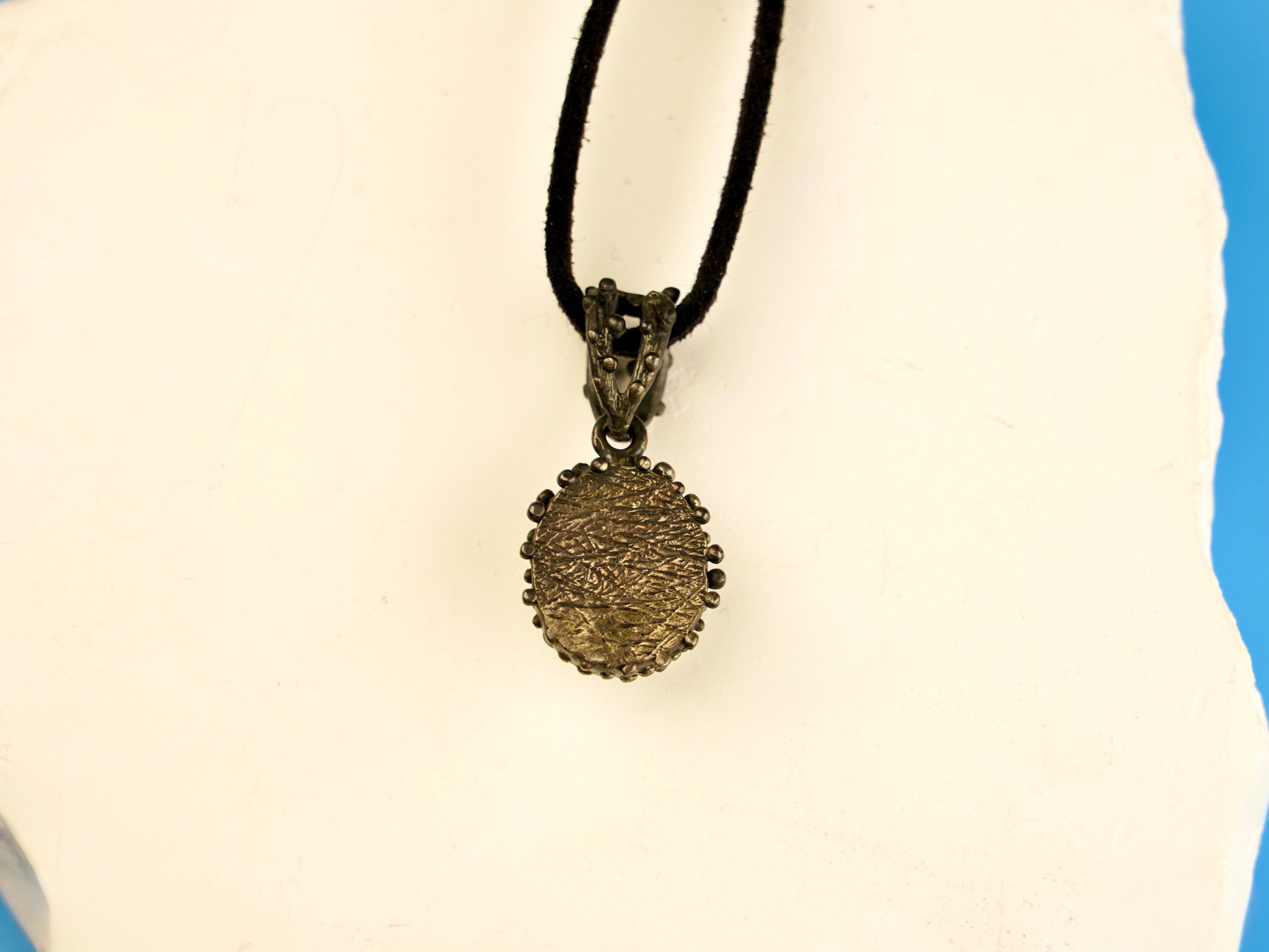 backside of moonstone pendant, sterling silver handcrafted jewelry detail