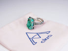 Handcrafted gemstone jewelry presentation with malachite ring on branded Akra jewelry pouch