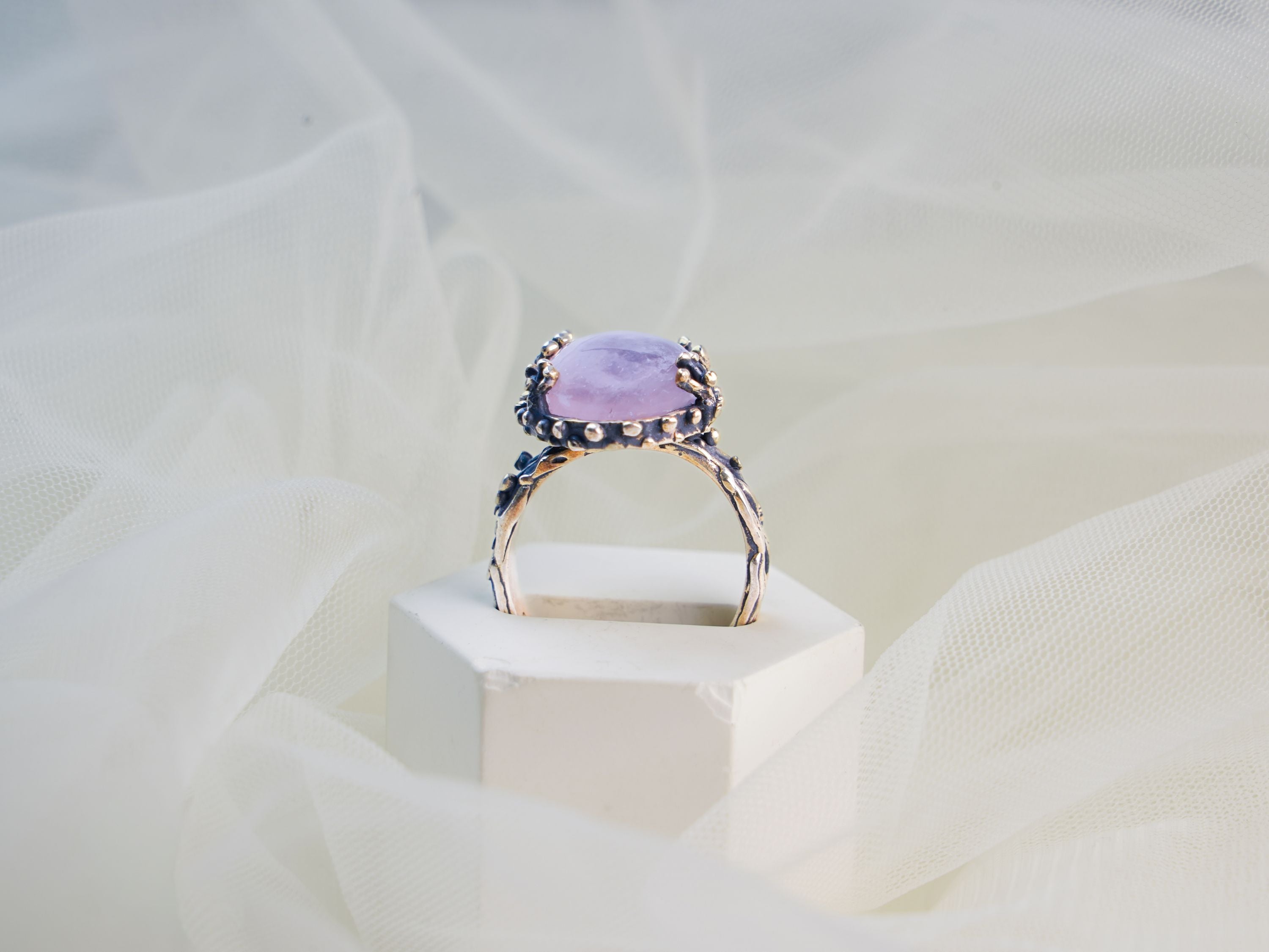 rose quartz ring profile view pink gemstone elevated setting ring
