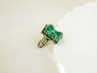 High-angle shot of a rectangular emerald green malachite ring on a white decorative platform