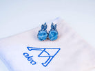 Aesthetic presentation of aquamarine jewelry on a branded Akra fabric jewelry pouch