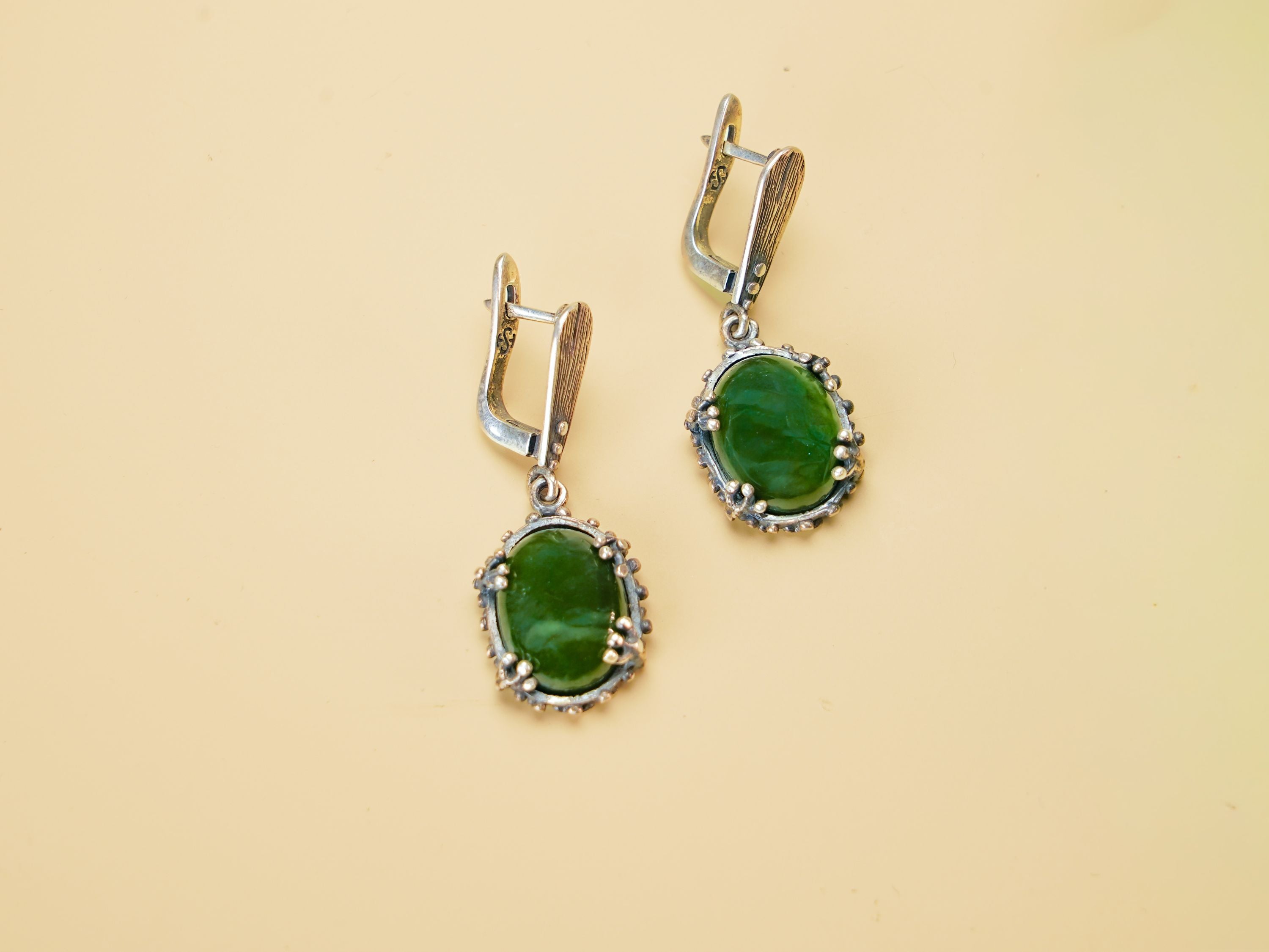 Alternative close up jade earrings green gemstone macro detail silver setting