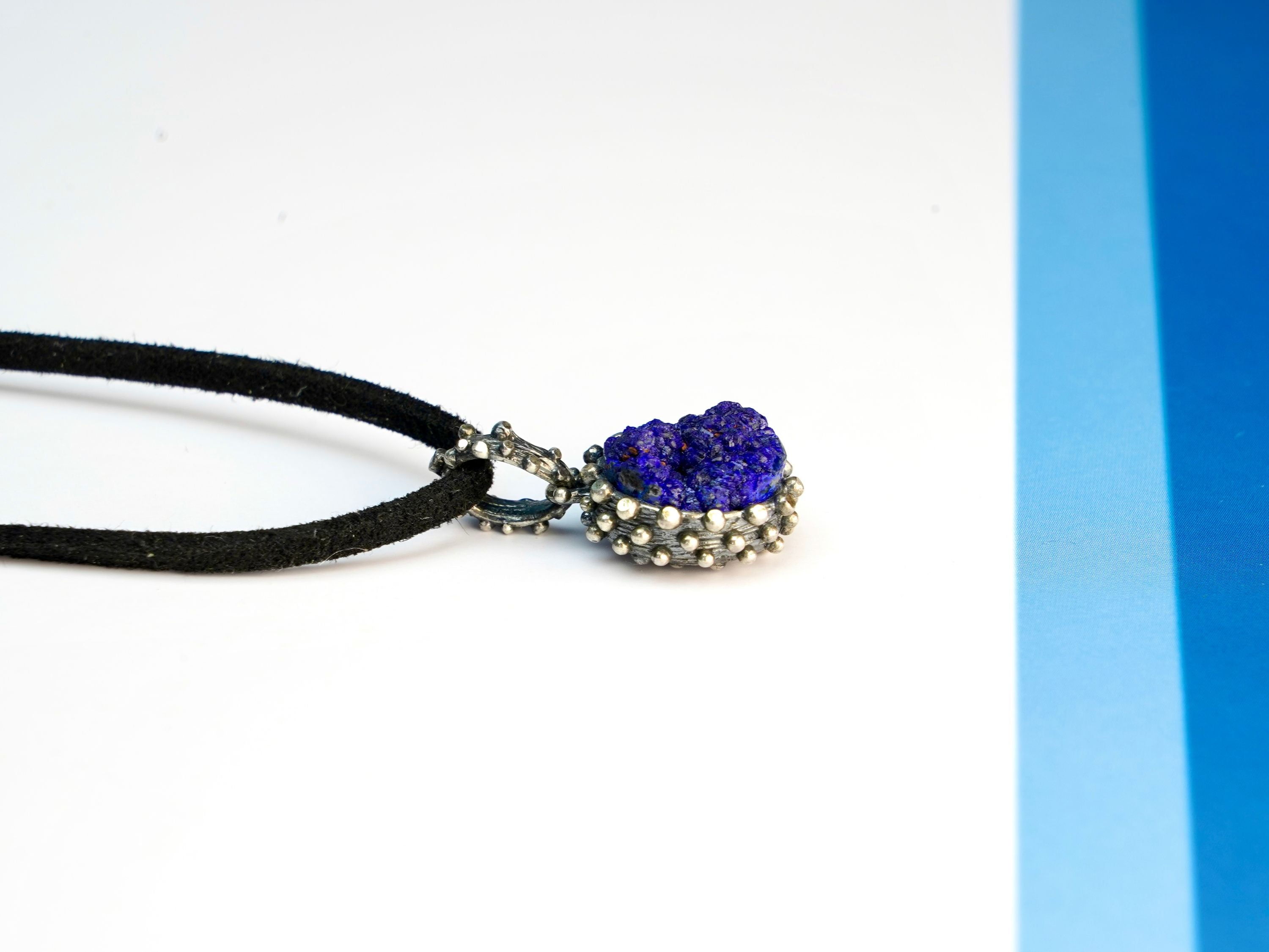 lapis lazuli pendant low angle view, elegant blue gemstone shine
