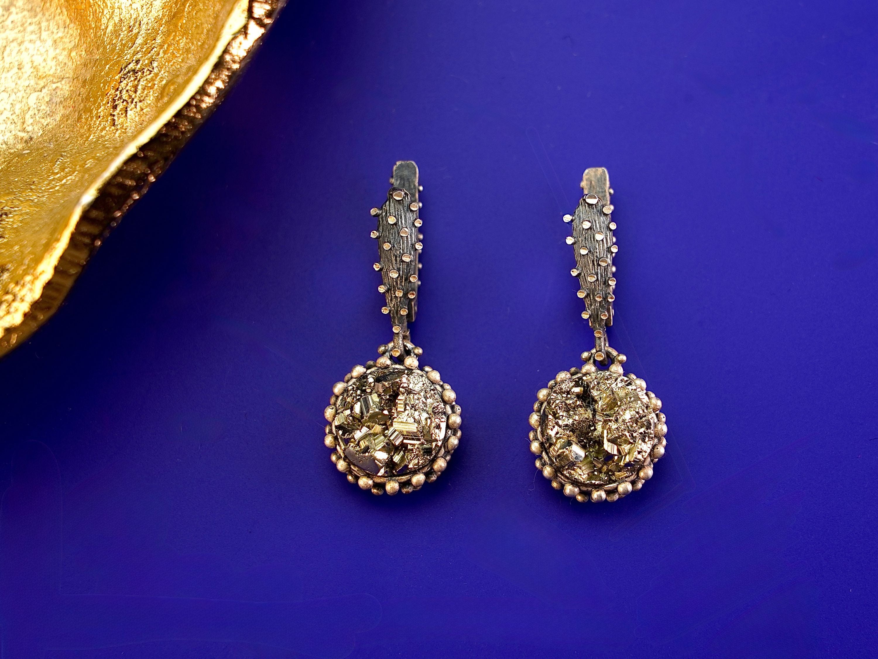 Detailed variation pyrite earrings gold crystal cluster texture macro shot