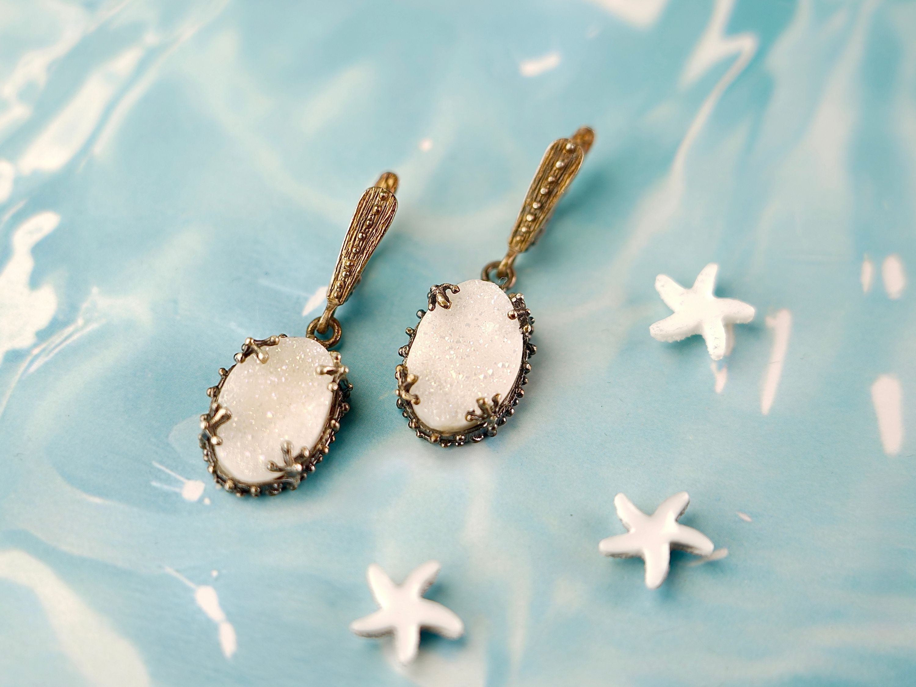 Alternative close up moonstone earrings glowing white stone macro detail variation