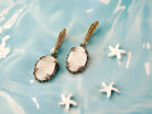 Alternative close up moonstone earrings glowing white stone macro detail variation