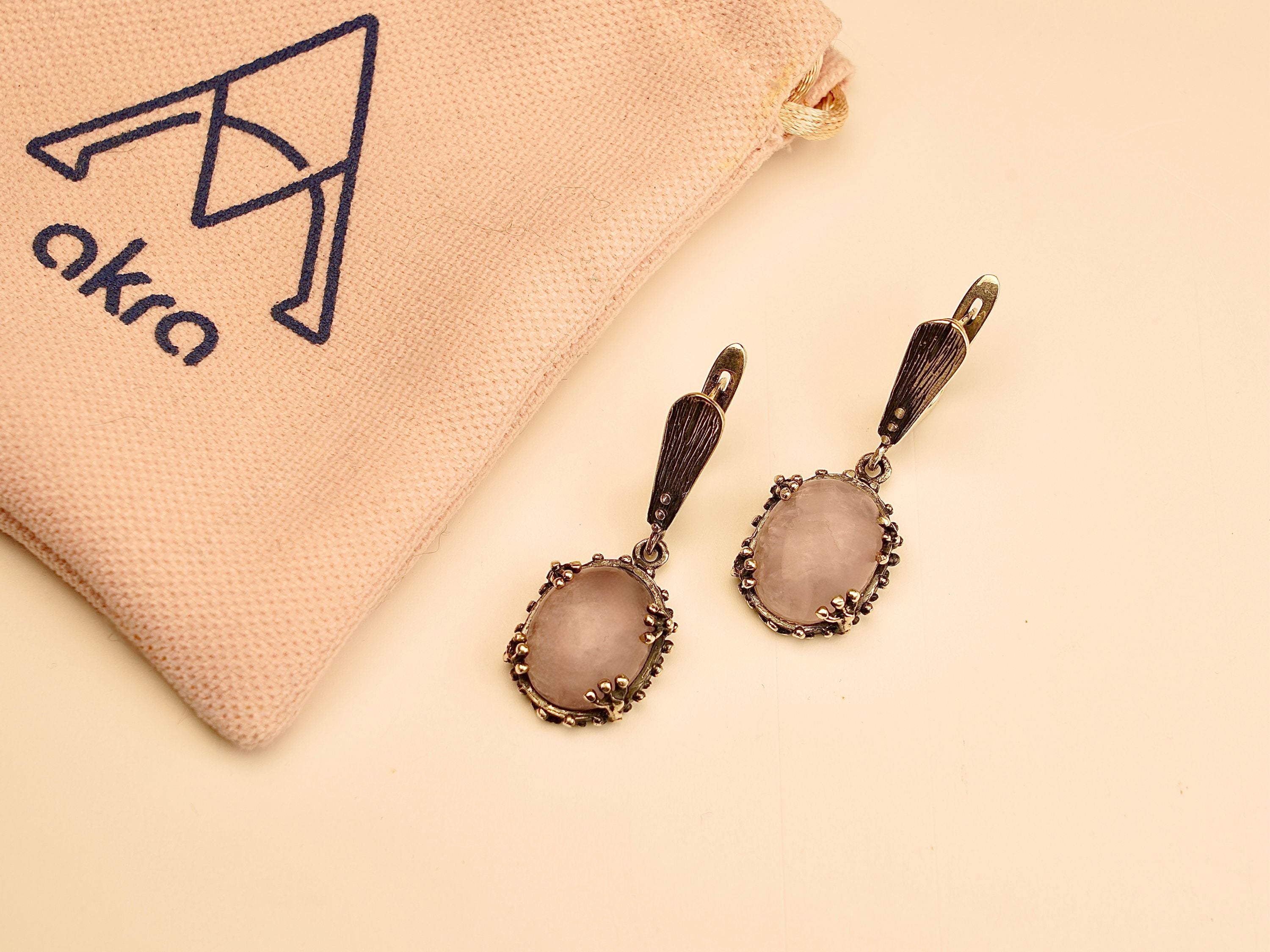 rose quartz earrings detail view, polished pink stone and silver craftsmanship