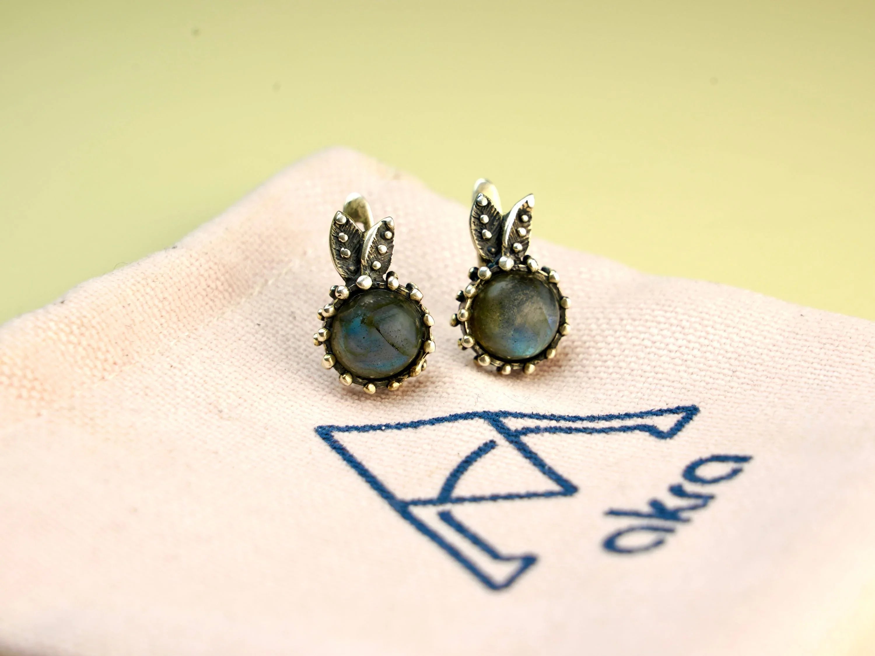 Minimalist labradorite earrings on fabric branding aesthetic jewelry photo
