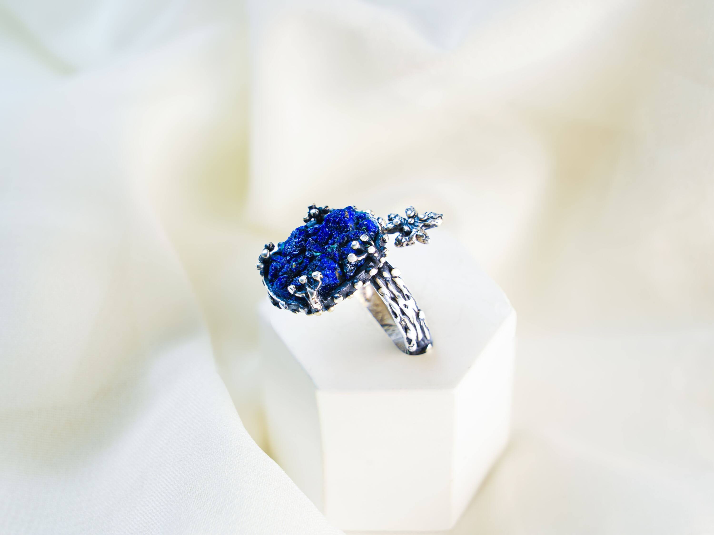 Vertical aesthetic shot of the handcrafted silver branch ring with a round lapis lazuli stone