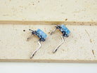 Top-down layout of the silver aquamarine earrings showing the open-back setting for light transparency