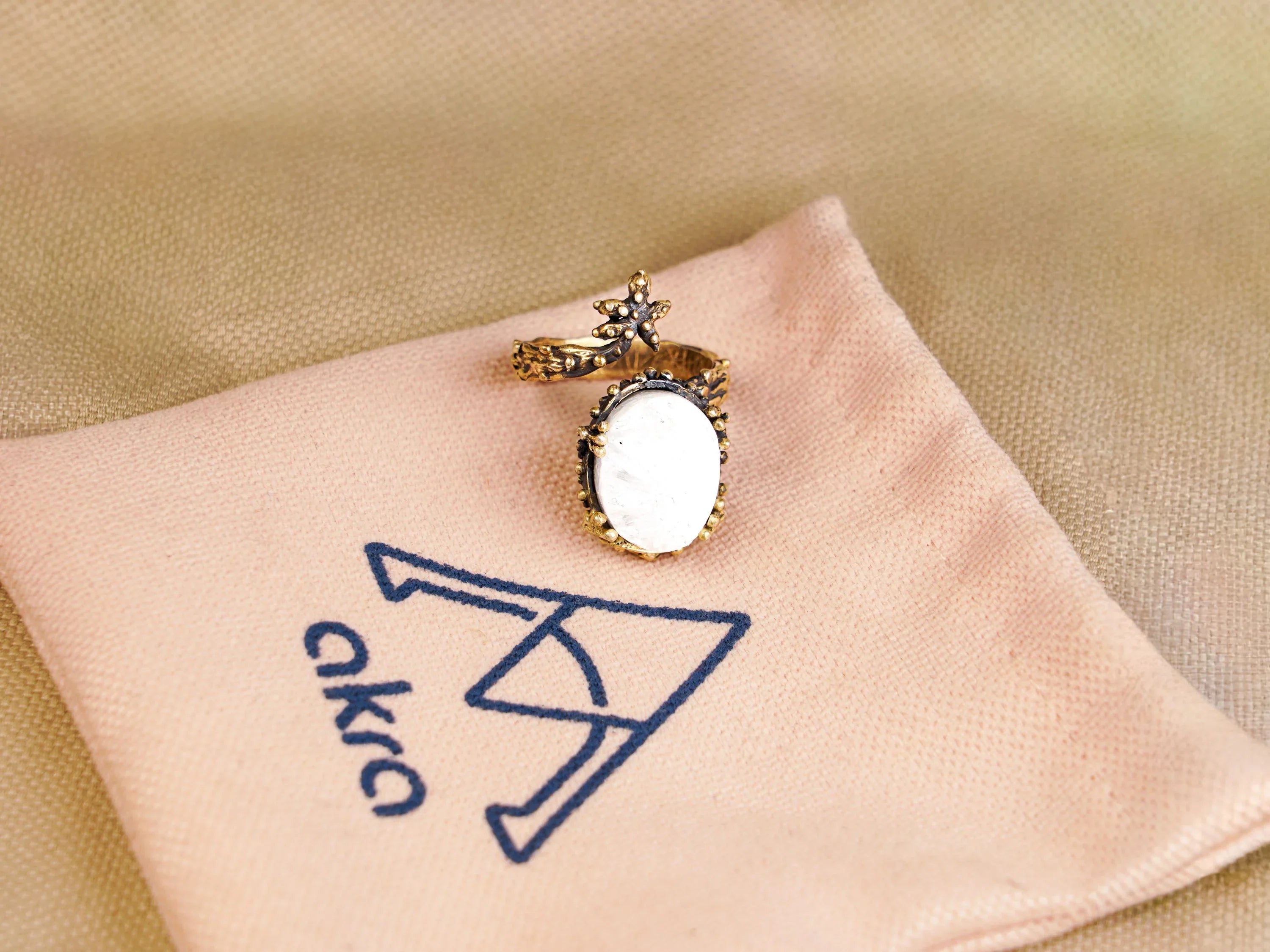 Moonstone ring on pouch branding jewelry presentation aesthetic