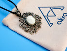 moonstone necklace lifestyle shot, artistic statement jewelry aesthetic