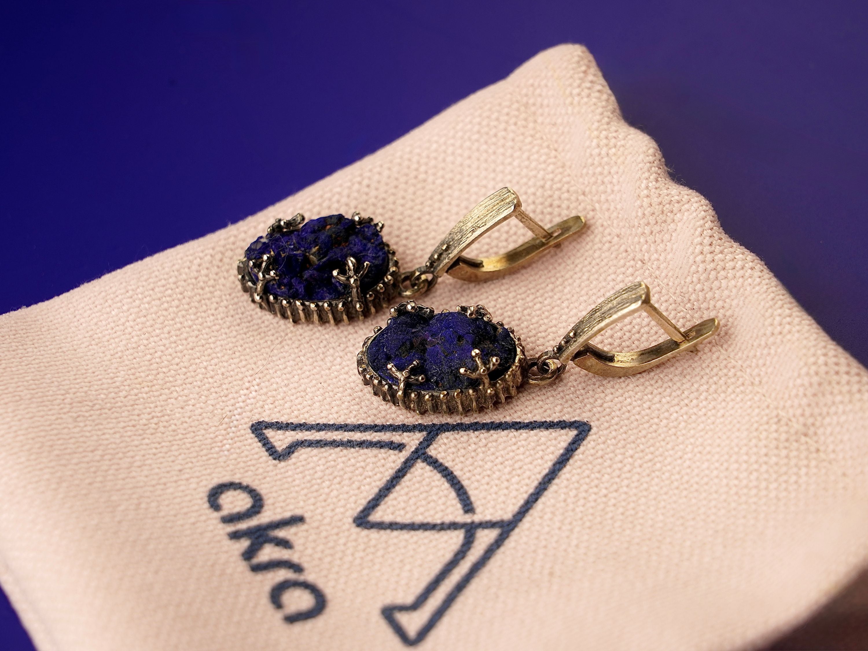 Lifestyle lapis lazuli earrings bold blue gemstone jewelry styled composition