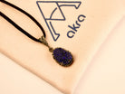 lapis lazuli pendant necklace lifestyle shot, minimal blue gemstone jewelry style