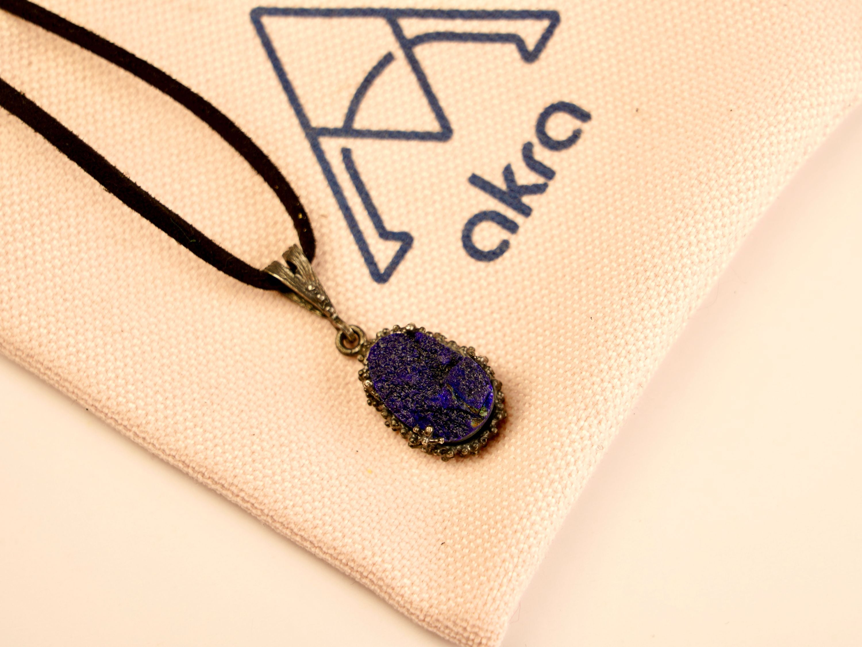 lapis lazuli pendant necklace lifestyle shot, minimal blue gemstone jewelry style