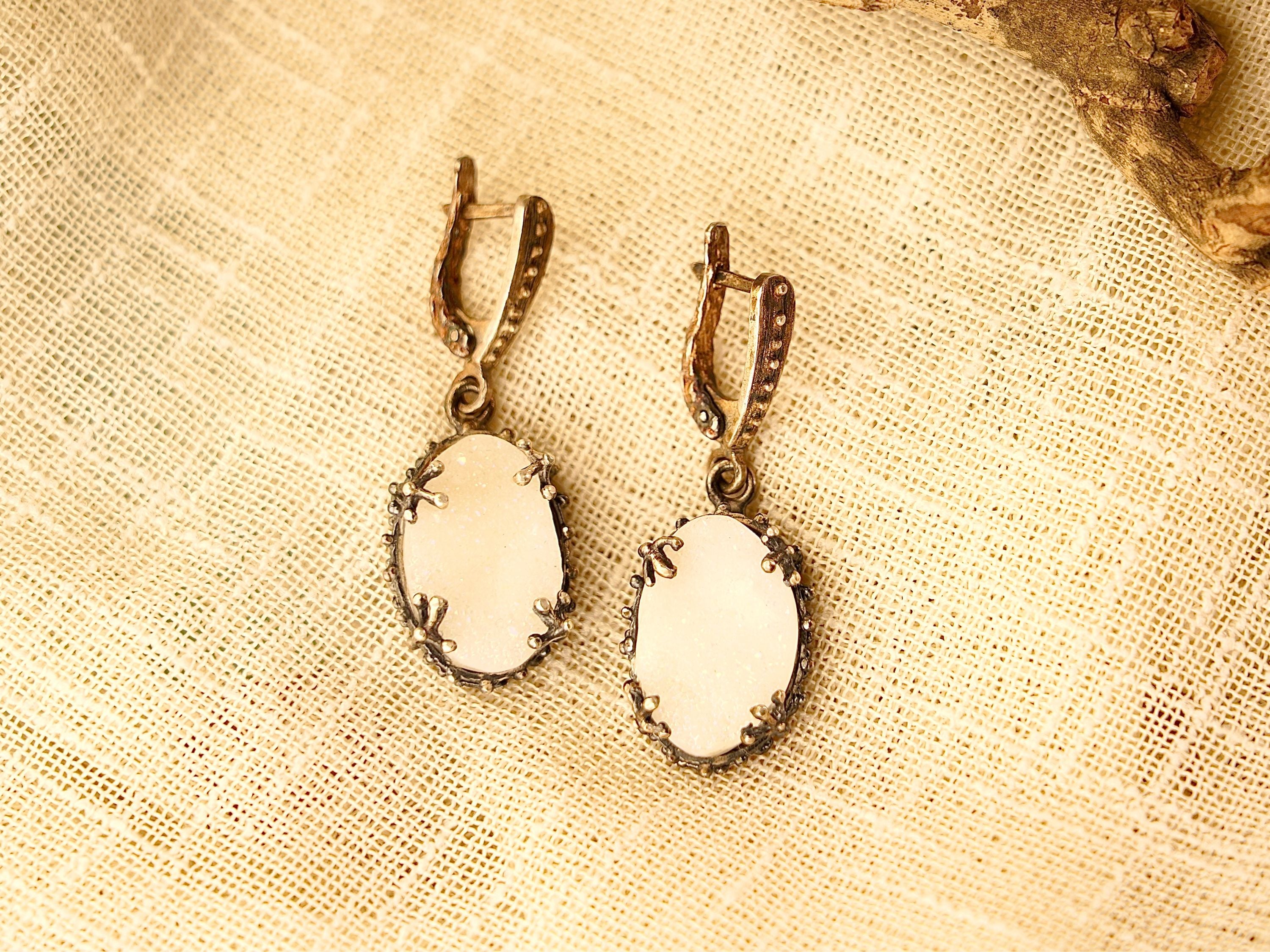 Lifestyle moonstone drop earrings elegant white gemstone jewelry styled composition