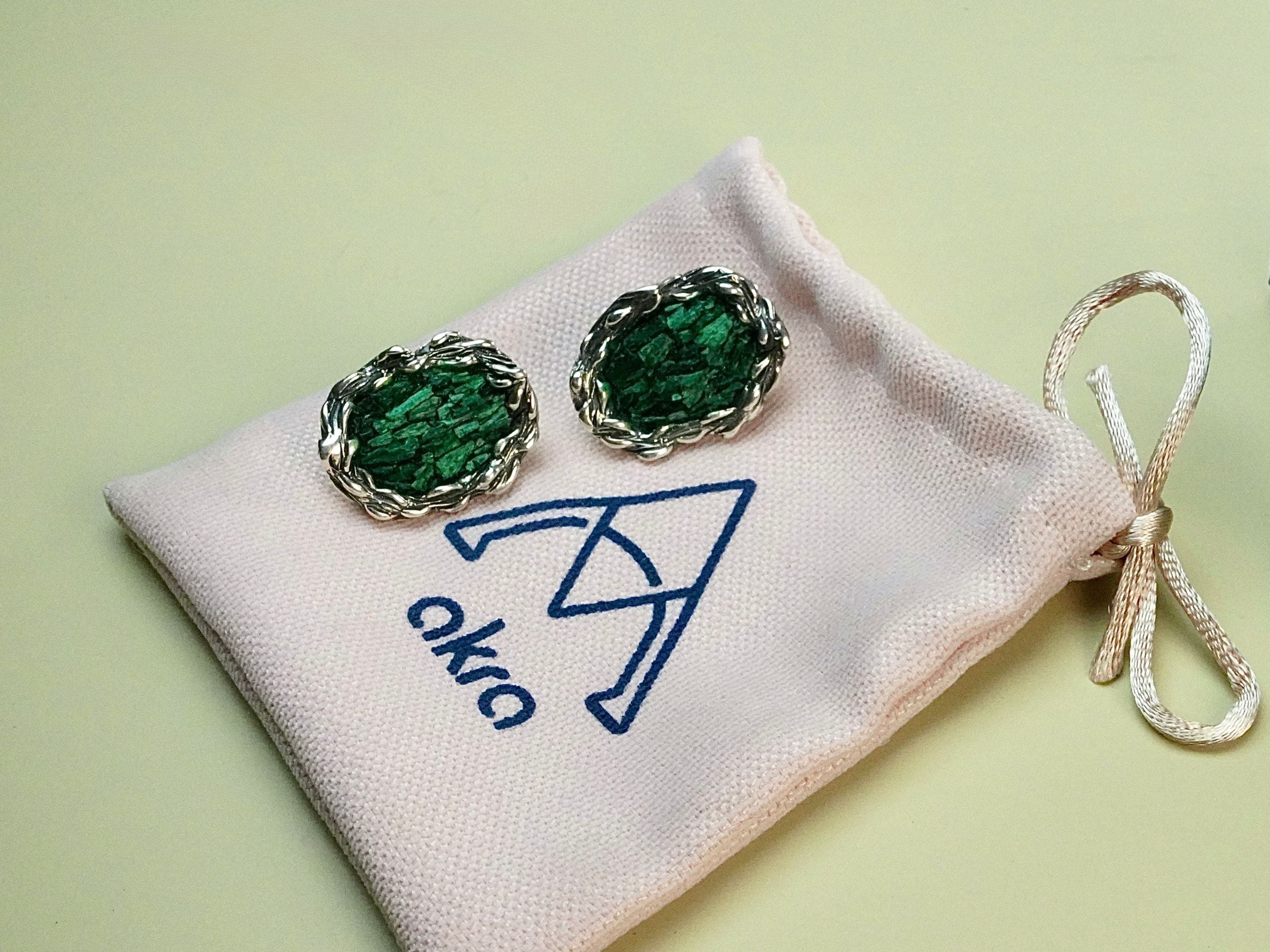 Lifestyle malachite earrings on hand natural green stone jewelry styling