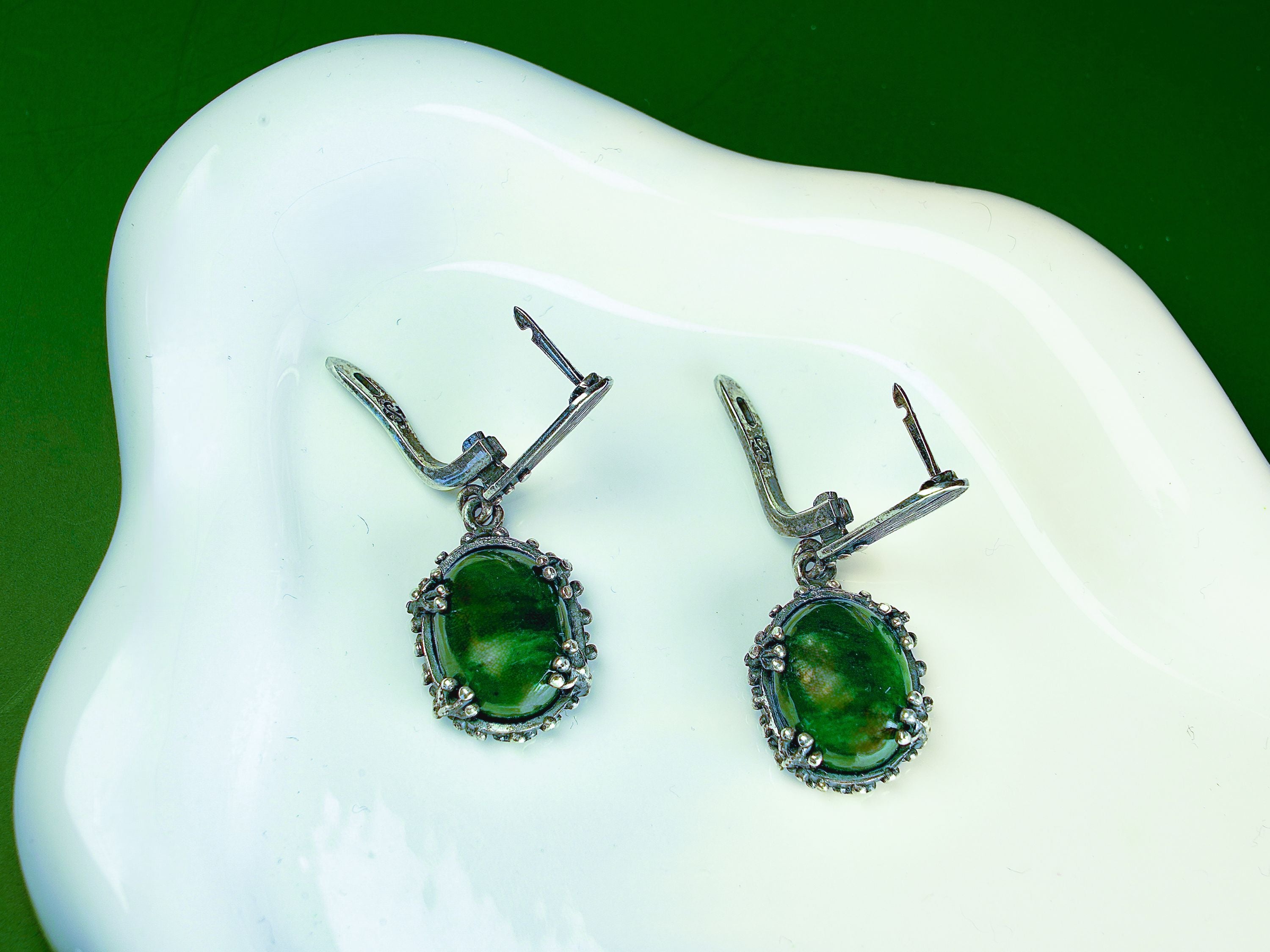 Lifestyle jade earrings green gemstone jewelry aesthetic styled composition