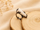 Close-up of the adjustable ring band, showing the dark textured finish and the flexible design suitable for various finger sizes.