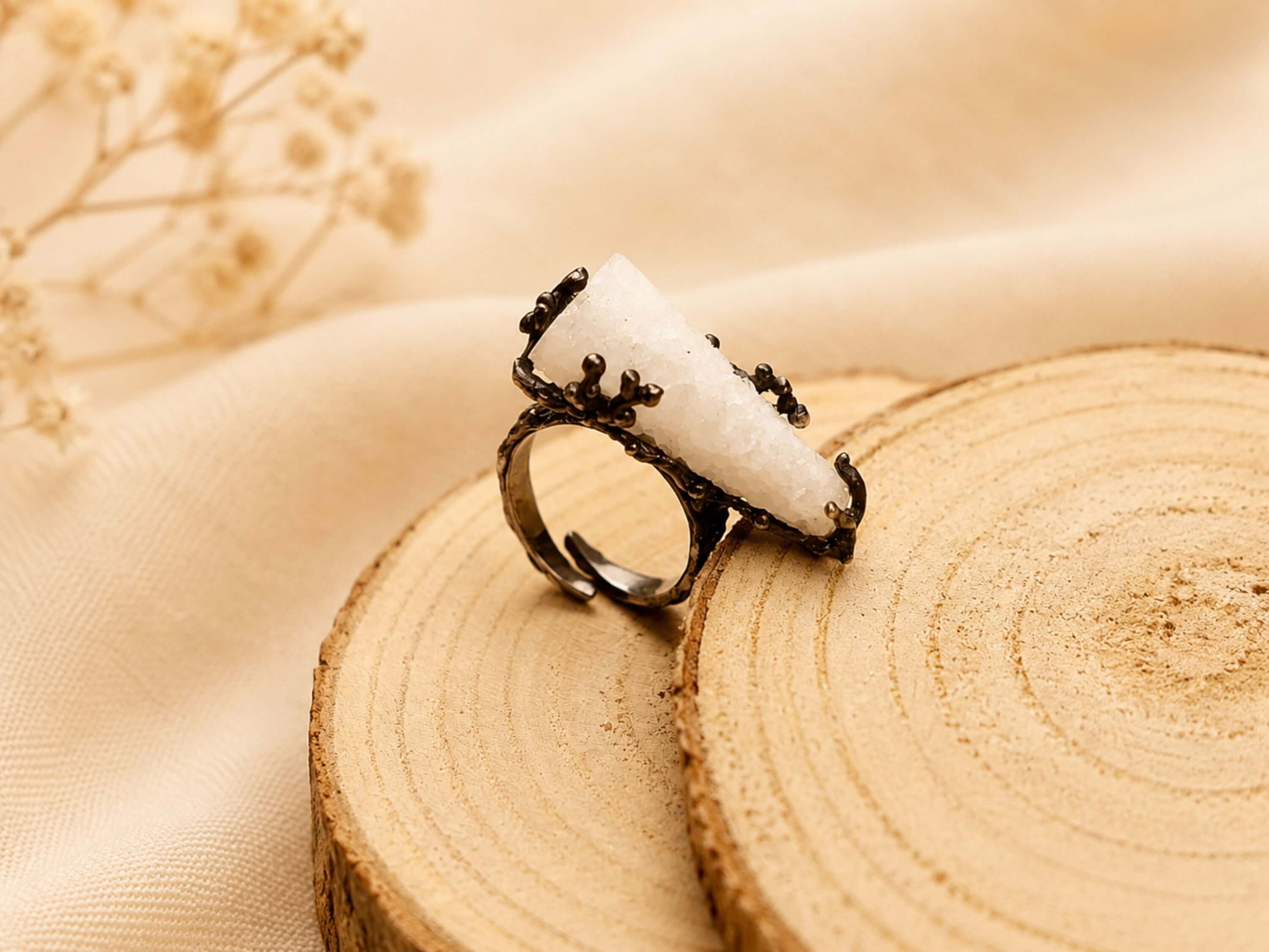 Close-up of the adjustable ring band, showing the dark textured finish and the flexible design suitable for various finger sizes.