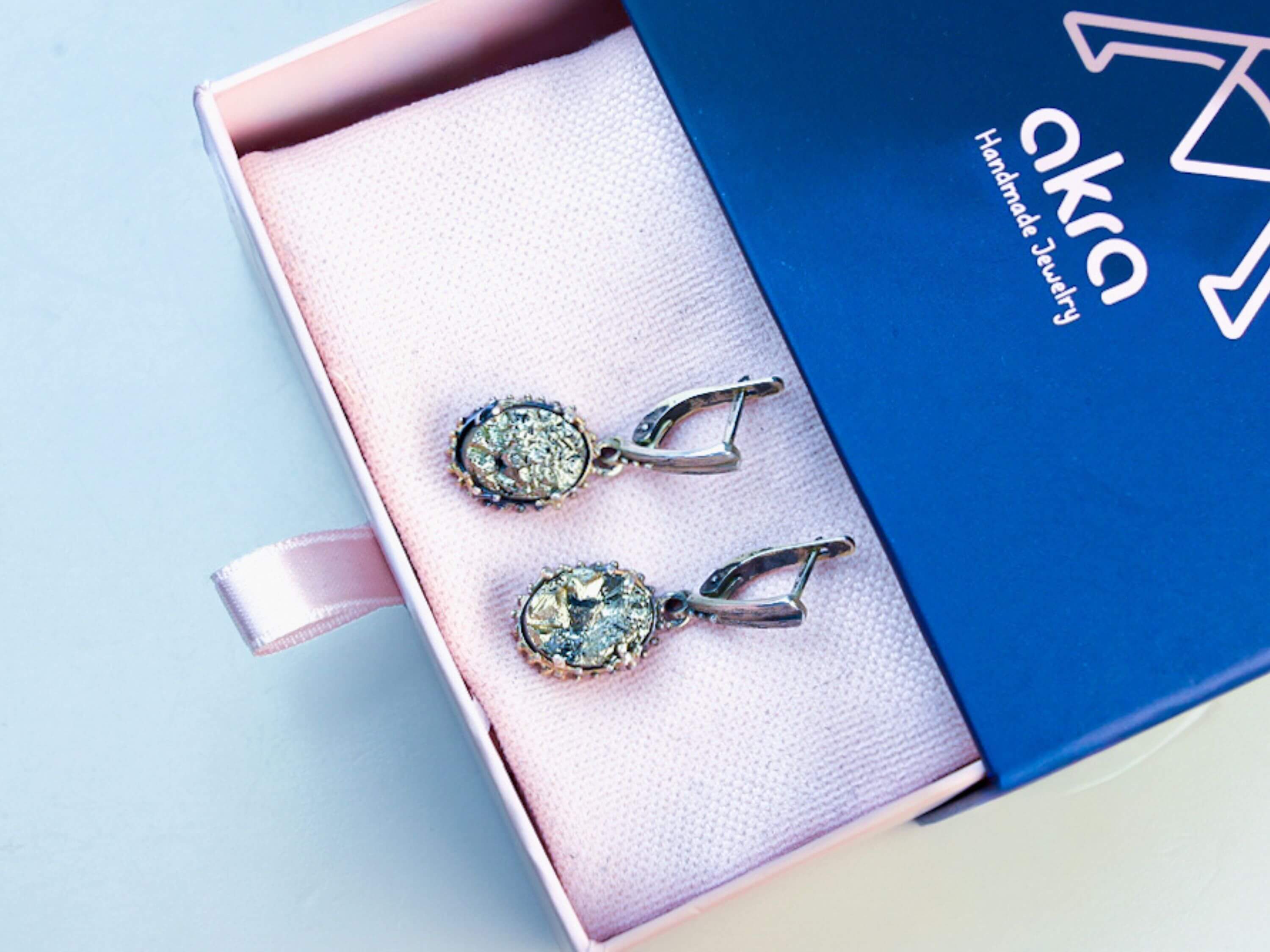 Golden Pyrite earrings inside an Akra Gems signature gift box, elegantly presented and ready for premium gifting