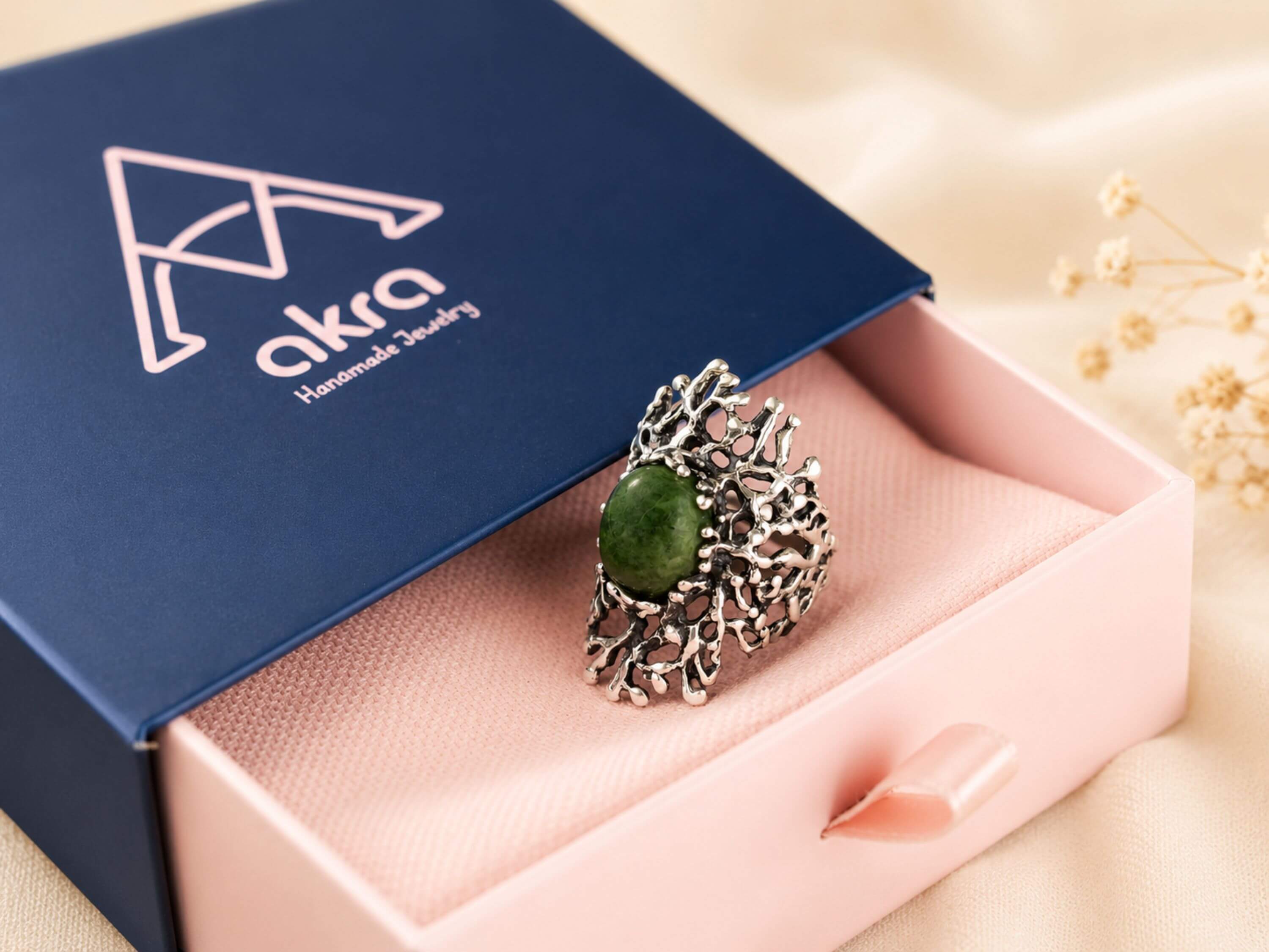 The green Jade statement ring presented in Akra Gems premium blue gift box, perfect for luxury gifting.