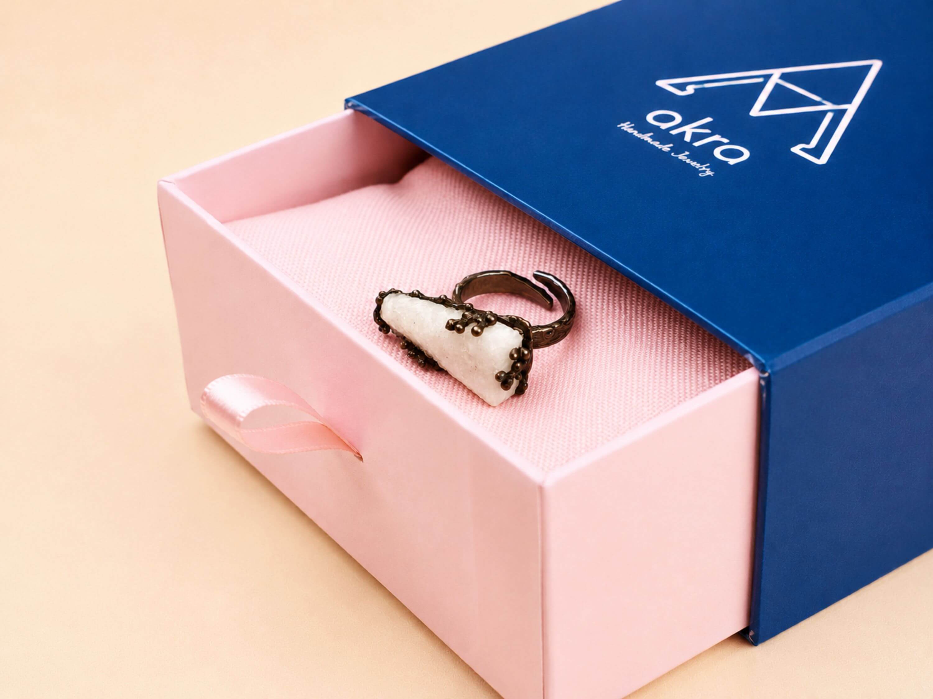The raw Moonstone ring presented in Akra Gems' premium blue and pink signature gift box, ready for high-end gifting.