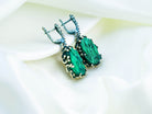 A pair of artisan malachite earrings, showcasing unique natural stones handcrafted by Akra Gems in Tbilisi