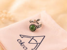 Mystical aesthetic shot of the raw green Jade ring, capturing its natural earthy energy and sophisticated handcrafted vibe.