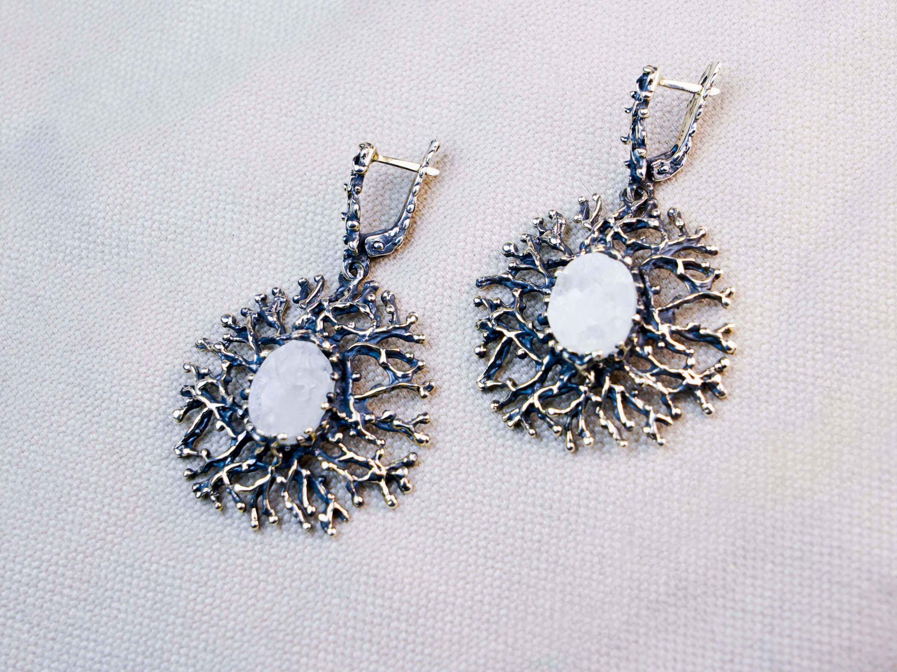 Statement Moonstone drop earrings featuring an intricate sterling silver branch design, showcased on a neutral background
