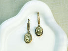 Oval Golden Pyrite earrings featuring glistening metallic gemstones in a detailed sterling silver frame, displayed on a clean background