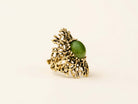 A massive green Jade statement ring featuring an intricate, organic sterling silver setting, displayed on a minimalist background.
