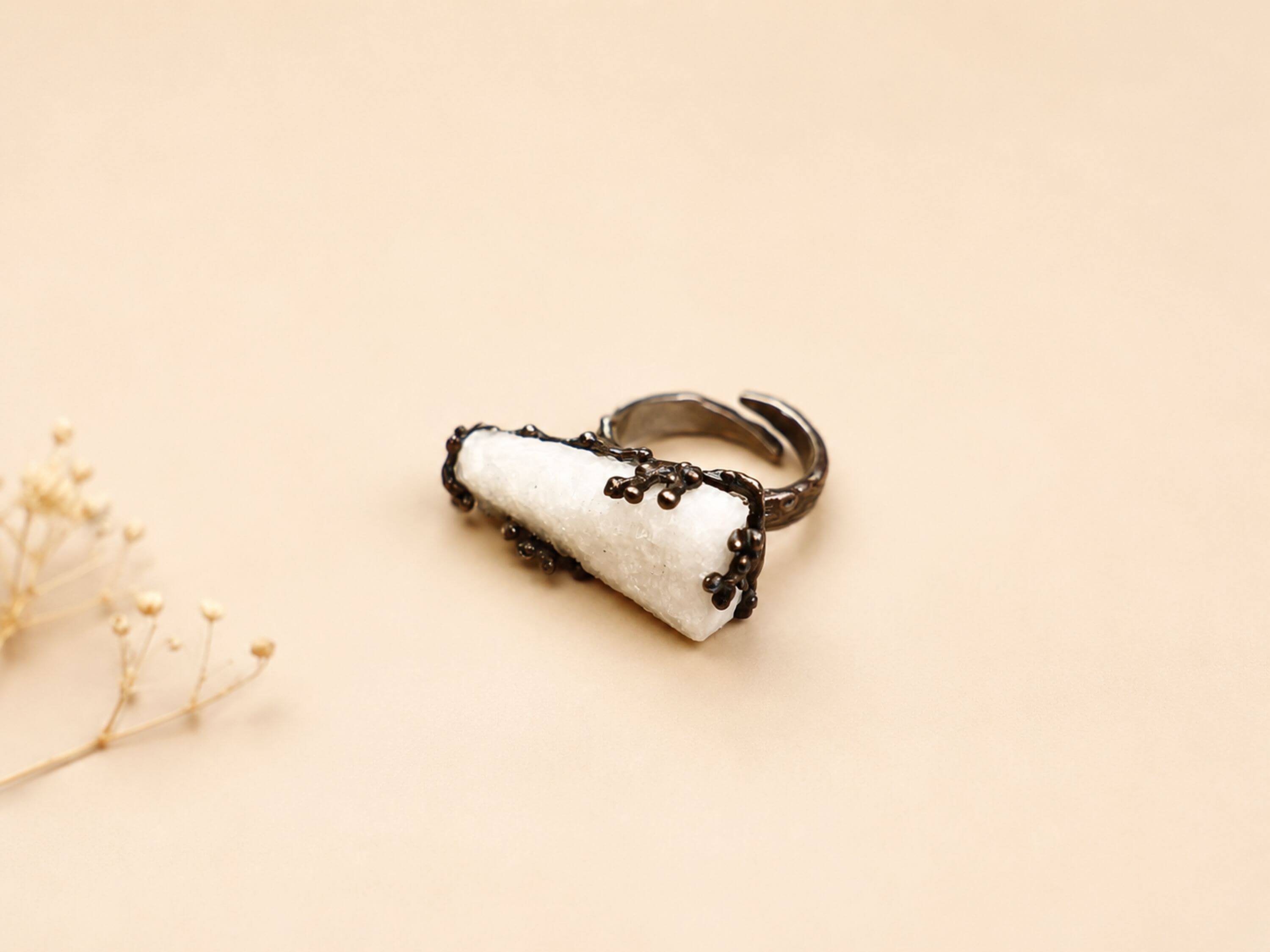 Front-facing view of the raw crystal ring, highlighting the asymmetrical, one-of-a-kind shape of the natural moonstone.