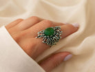 A model wearing the bold Akra Gems Jade ring, showcasing its impressive scale and the vibrant green color of the gemstone on a finger.