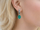 Side profile view of a woman wearing Akra Gems natural Malachite oval earrings, illustrating the size and elegant hang of the gemstone jewelry