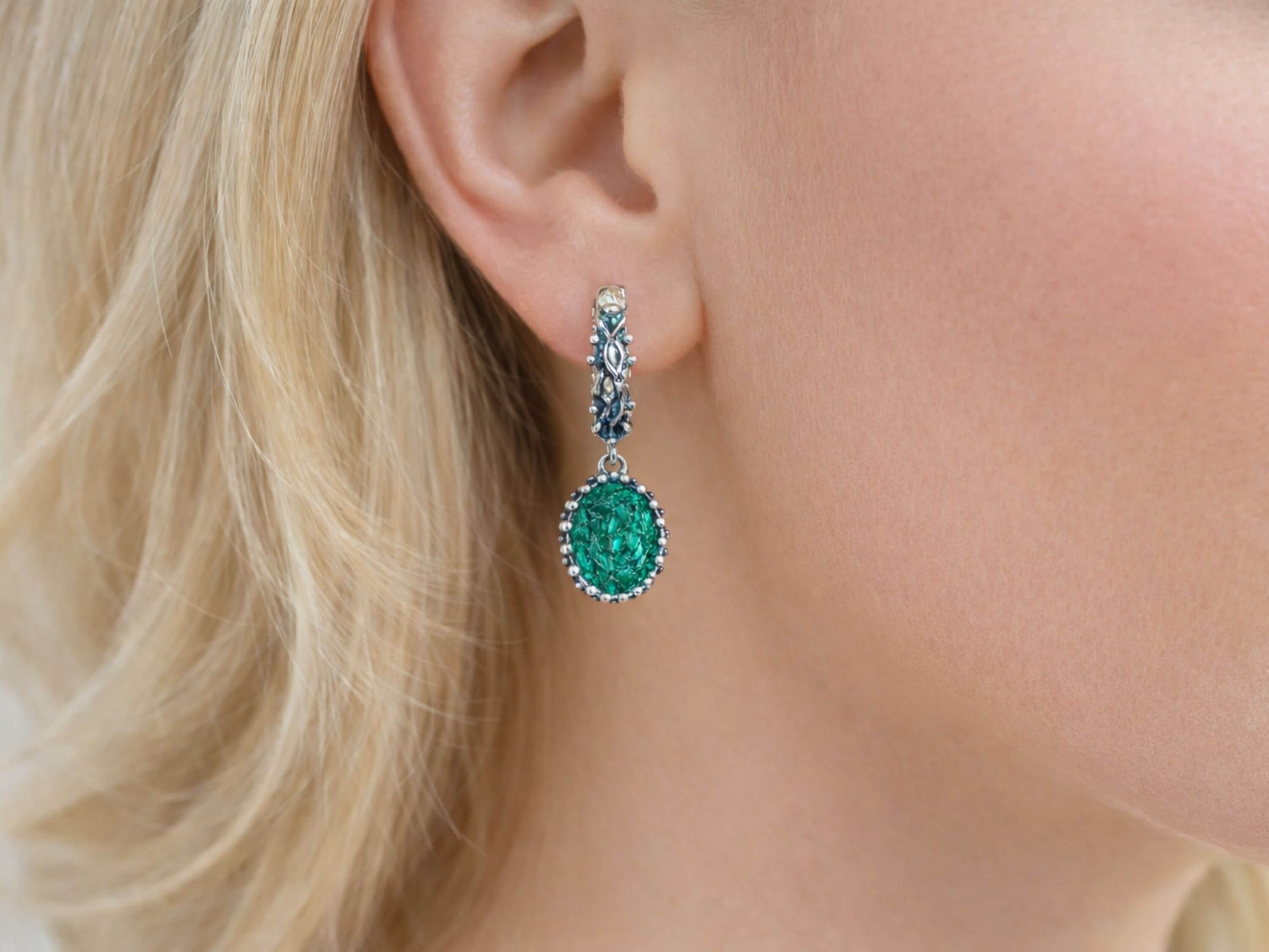 Side profile view of a woman wearing Akra Gems natural Malachite oval earrings, illustrating the size and elegant hang of the gemstone jewelry