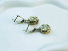 Side profile of the oval pyrite earrings, showing the depth of the stone and the intricate texture of the silver setting