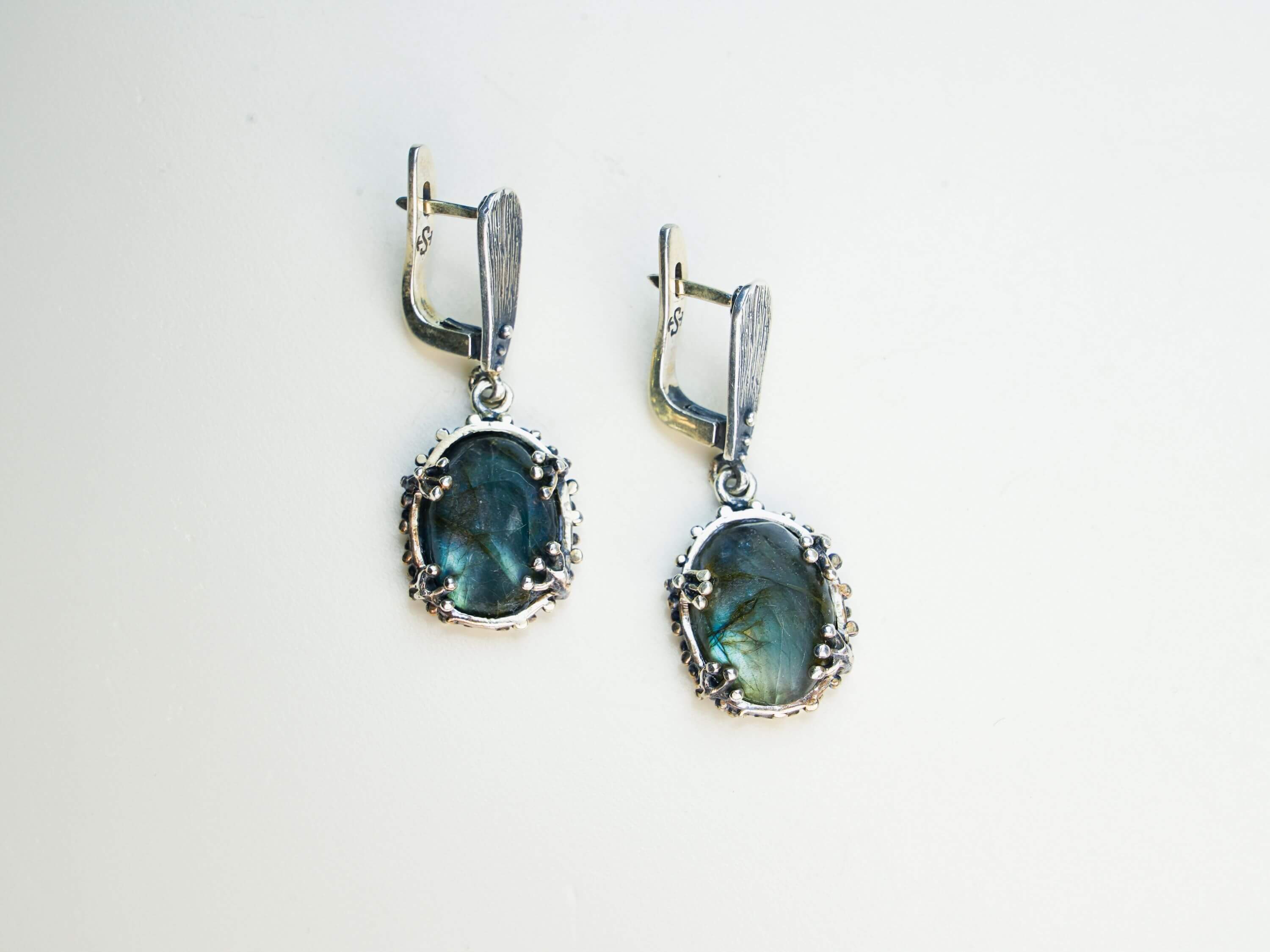 Natural labradorite earrings styled with a vintage aesthetic, emphasizing the mystical blue glow  