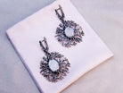 Mystical aesthetic shot of Moonstone earrings paired with natural elements, highlighting the raw and organic jewelry design
