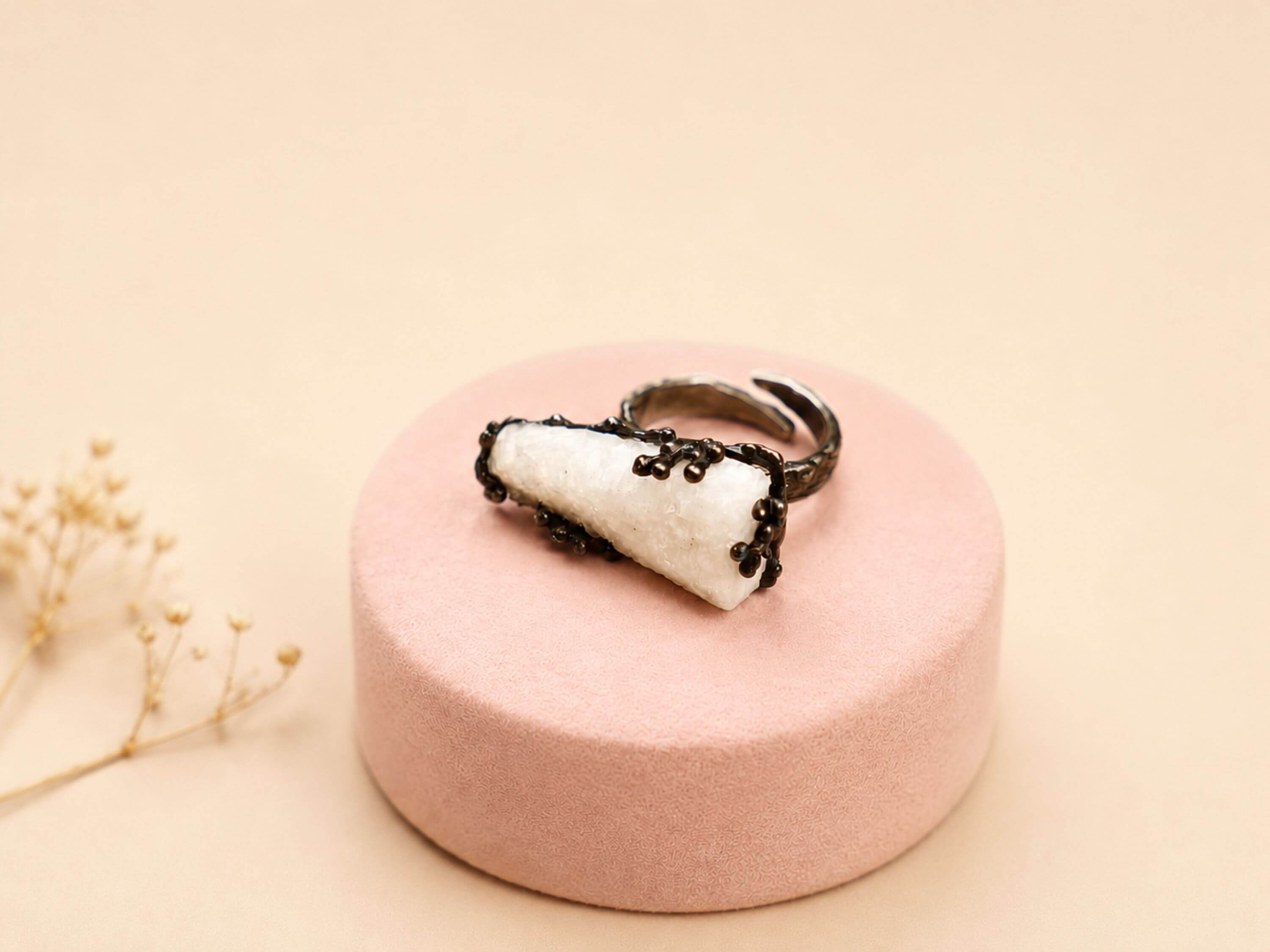 Side view of the Moonstone ring, emphasizing the unique organic texture of the oxidized sterling silver setting and the stone's elevation.