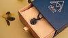 A close-up rotation of the raw black crystal pendant, displaying its natural texture, shimmering gothic silver setting, and elegant handmade gift packaging