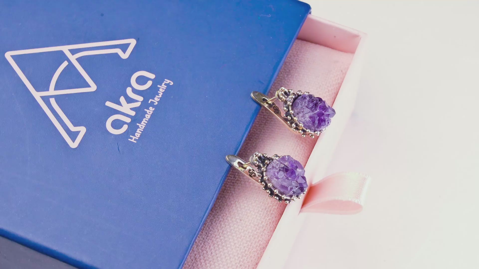 Product video capturing the natural shimmer of raw amethyst crystals and the elegant movement of the sterling silver oval dangles