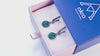 Video tour of handcrafted Malachite oval earrings, showing the 360-degree view, the movement of the dangles, the unique stone patterns in daylight, and the detailed sterling silver setting