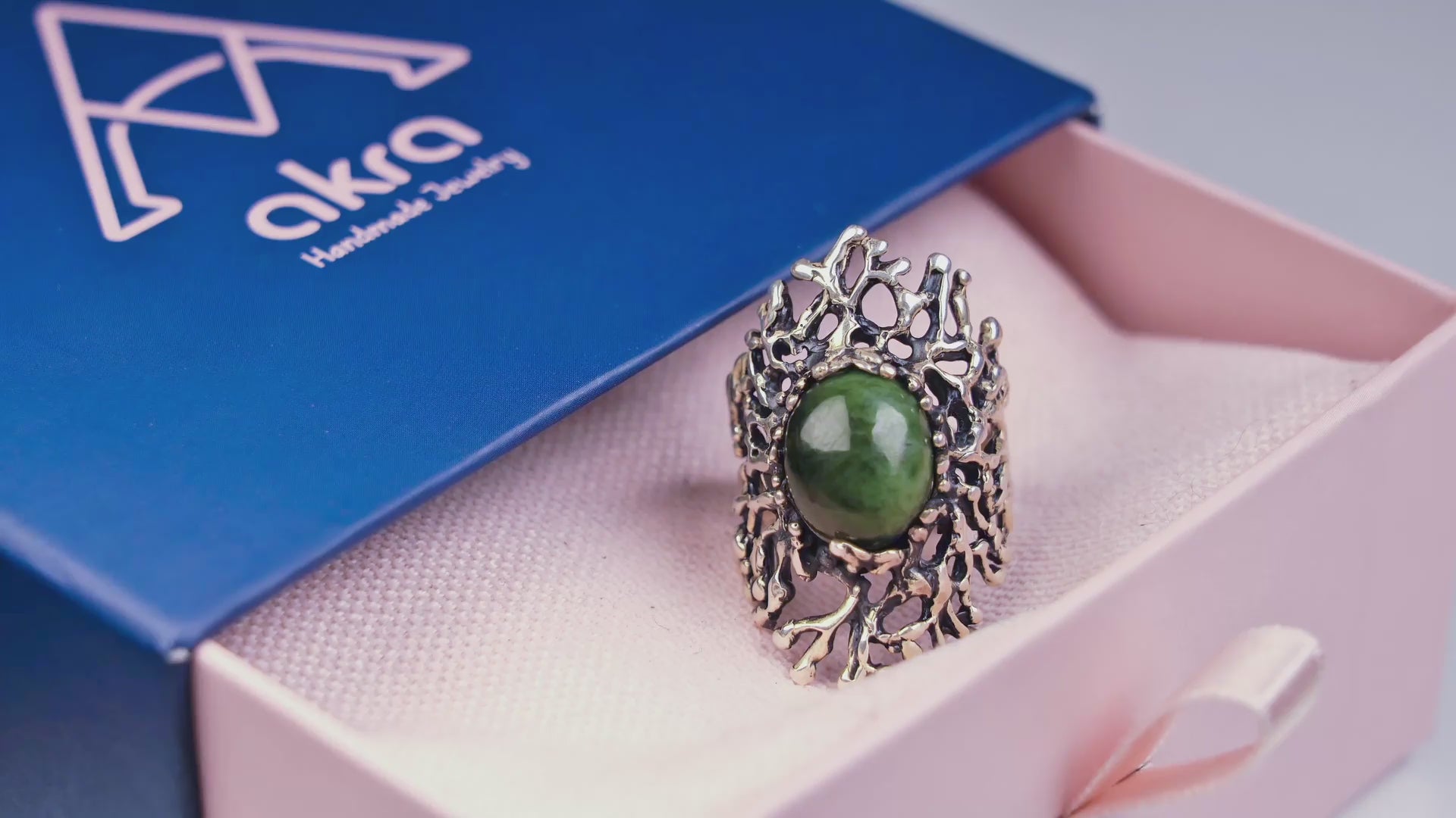 Product video showcasing the 360-degree detail of the green Jade statement ring, highlighting the shimmering gemstone and the intricate organic silver design.