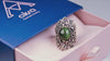 Product video showcasing the 360-degree detail of the green Jade statement ring, highlighting the shimmering gemstone and the intricate organic silver design.
