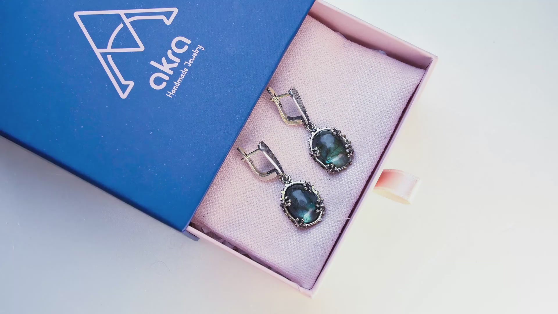 Close-up video of Akra Gems Labradorite earrings, capturing the magical blue glow of the natural stone under shifting light