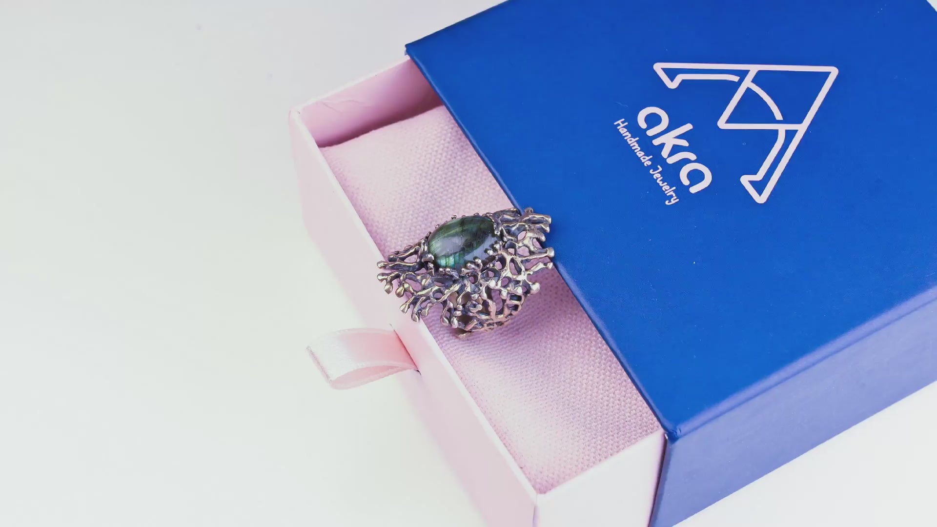 Cinematic video showing the color-shifting iridescence of the labradorite stone and the gothic silver details